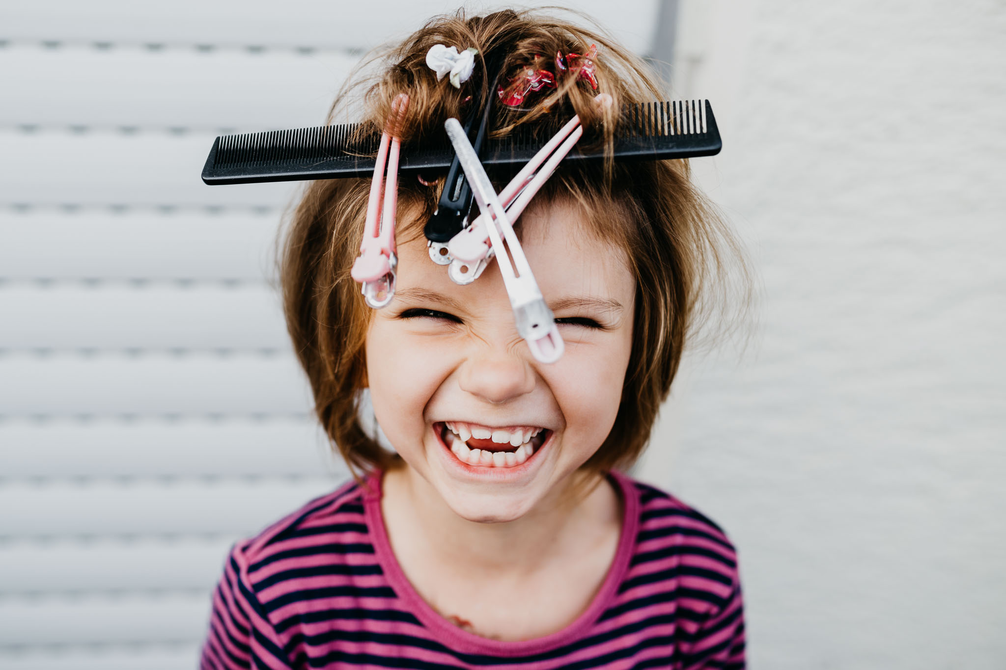 Portrait eines Mädchens mit Kamm und Klammern auf dem Kopf